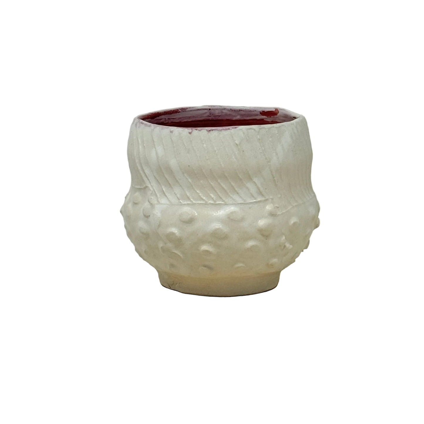 Ceramic white cup with textured surface on a light gray background
