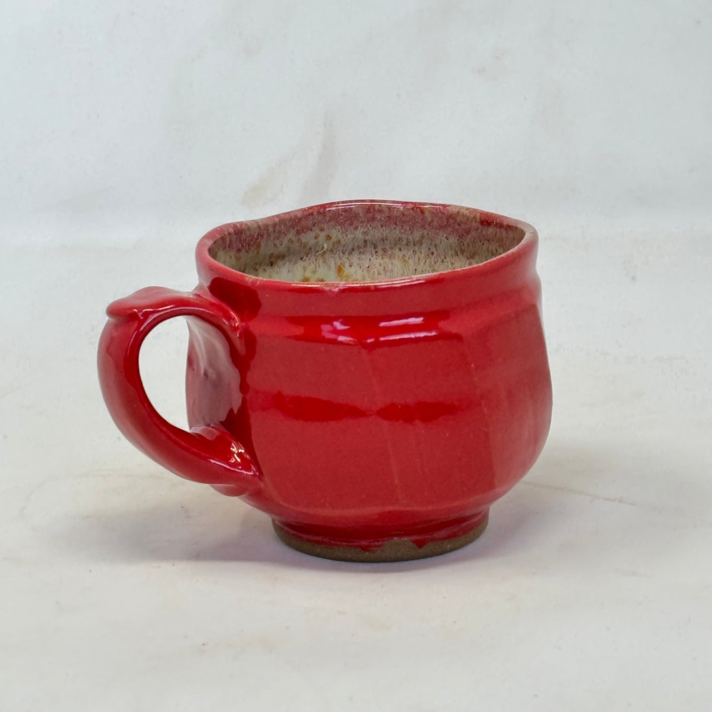 Red ceramic mug on a white background