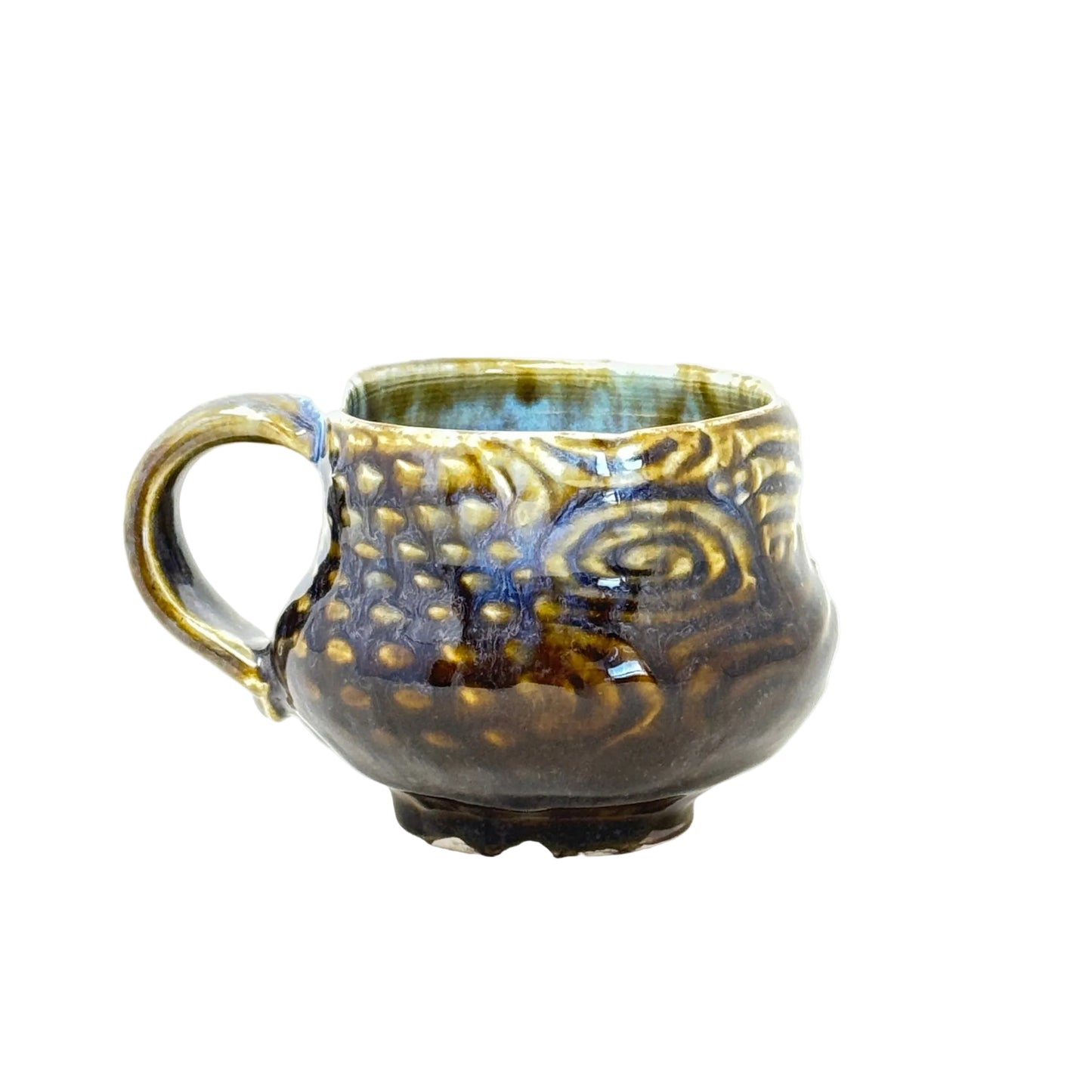 Decorative ceramic cup with gold and blue patterns on a white background