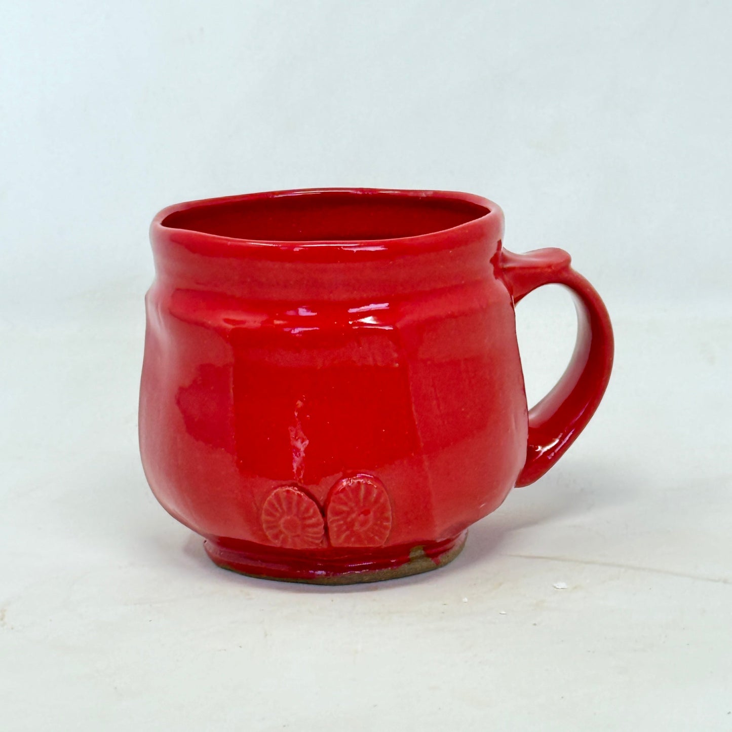 Red ceramic mug on a white background
