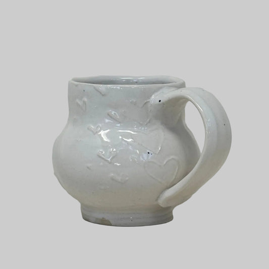 White ceramic mug with floral design on a white background