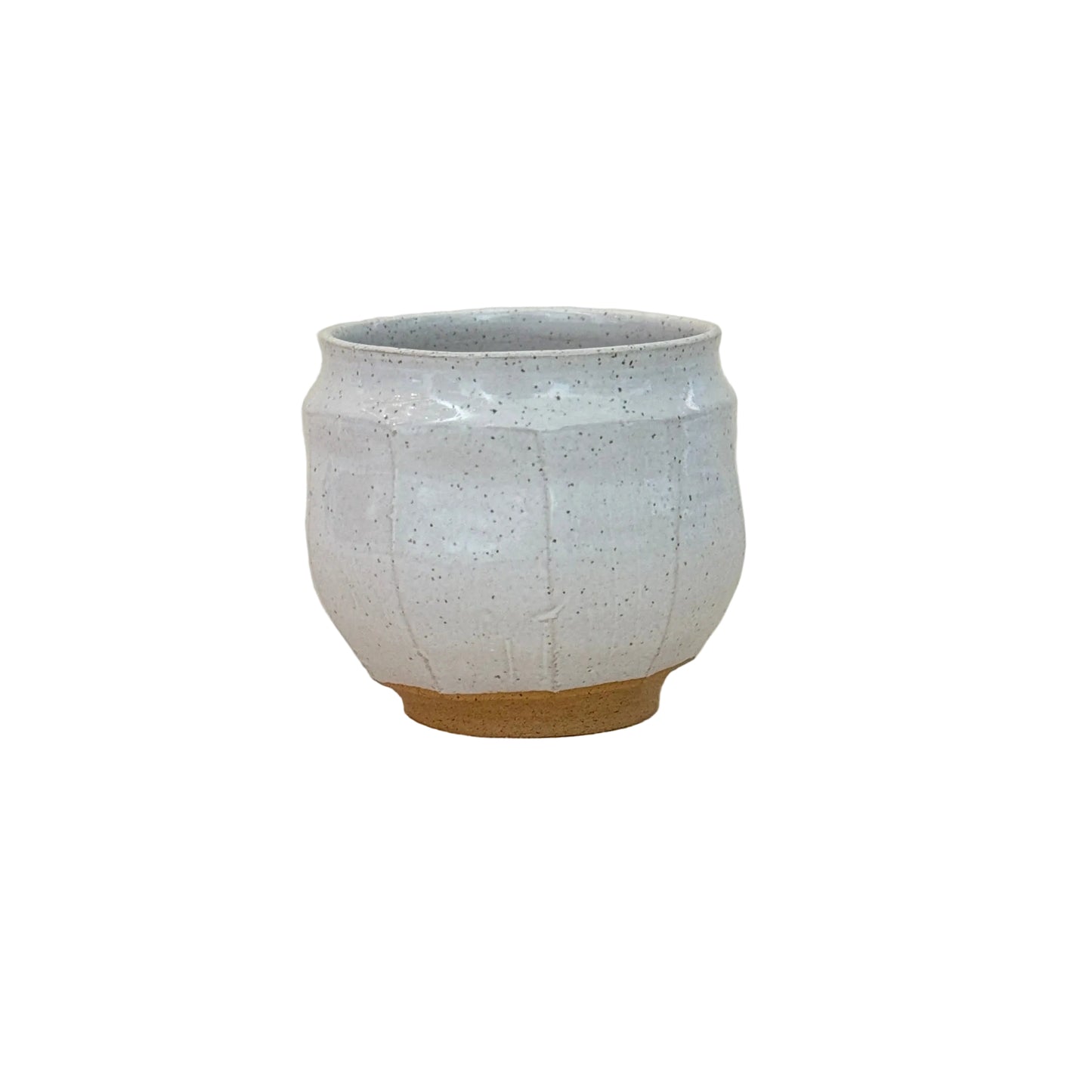 Small white ceramic bowl on a textured surface