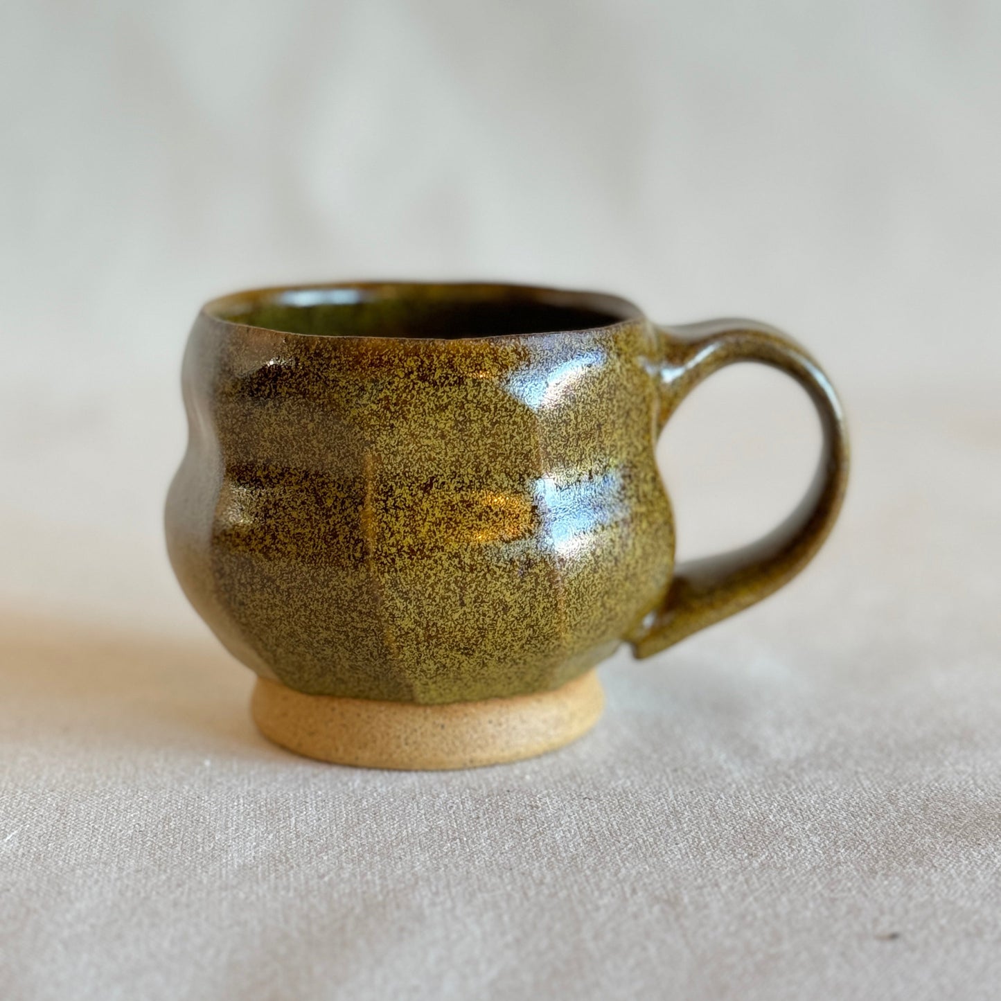 Green ceramic mug on a light gray background
