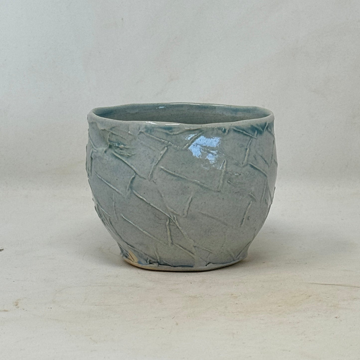 Ceramic bowl with textured surface on a plain background