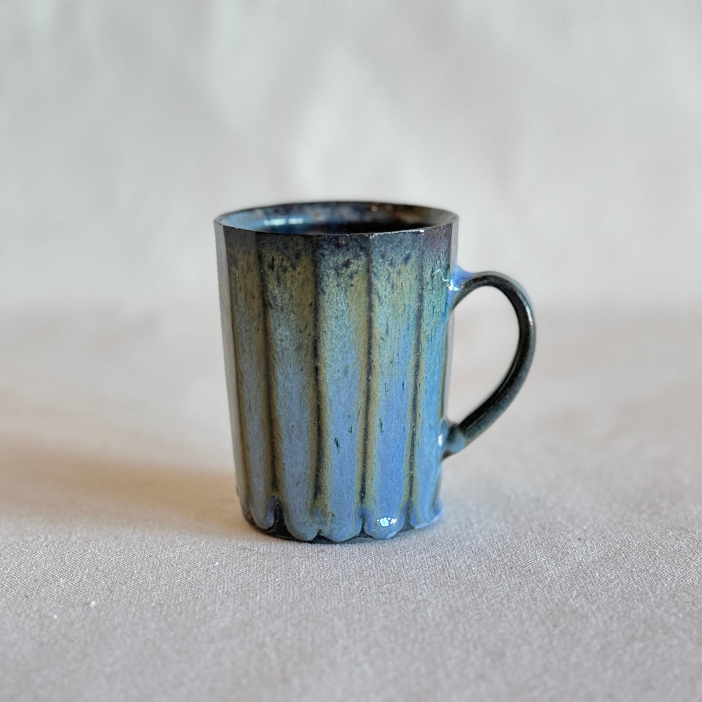 Blue ceramic mug on a light gray background