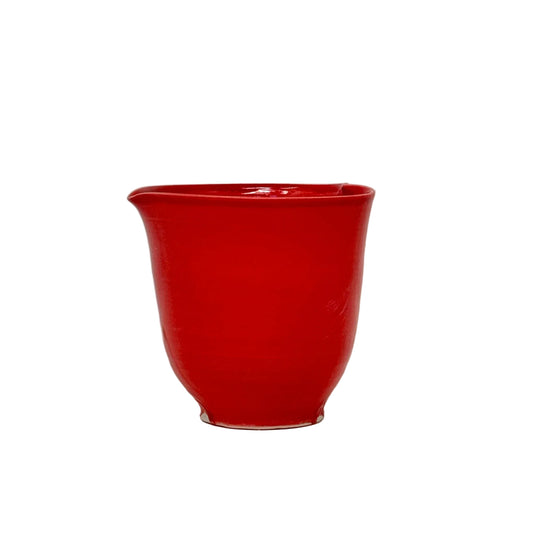Red ceramic cup on a white background