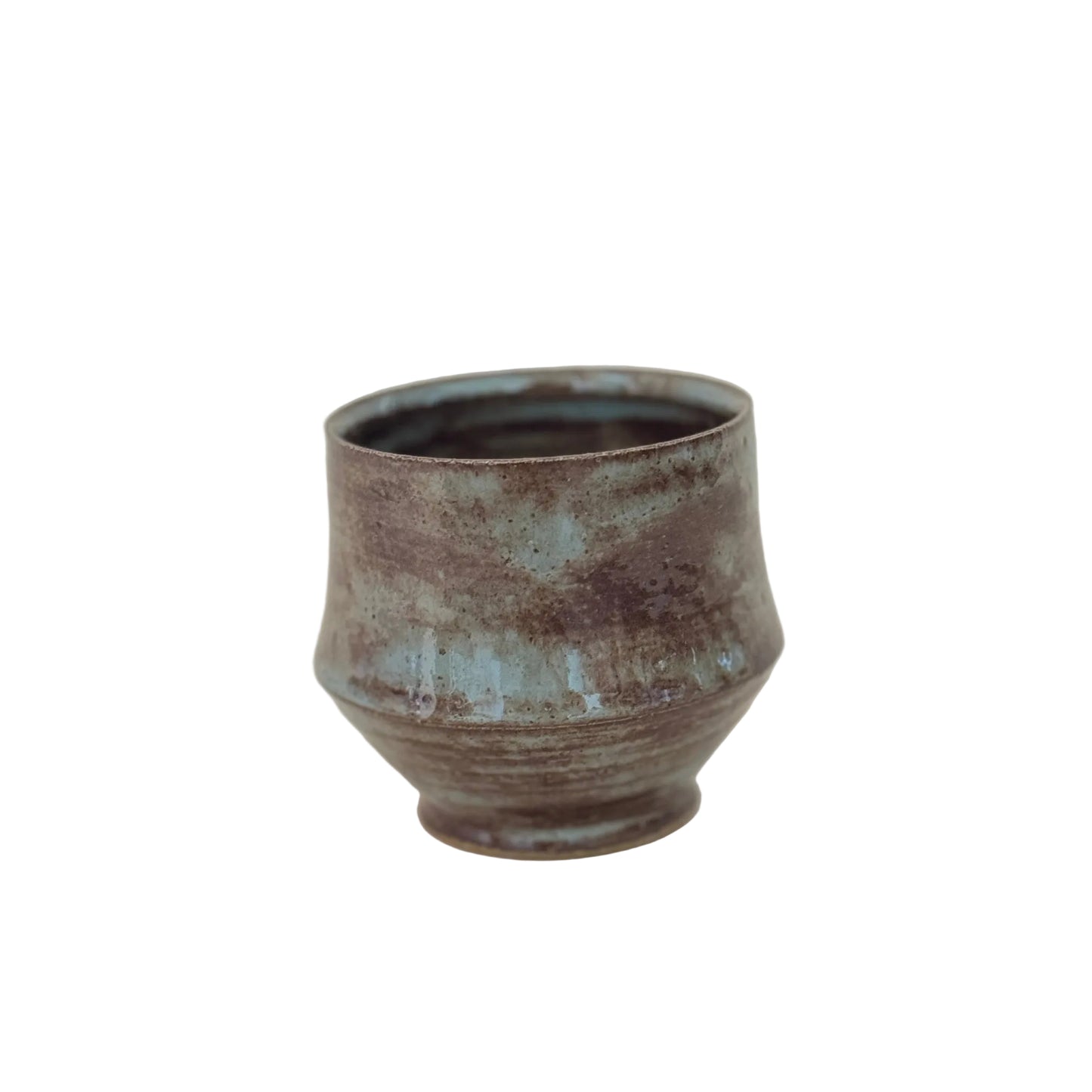 Ceramic cup with a textured surface on a light gray background