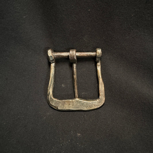 Bronze belt buckle on a dark background