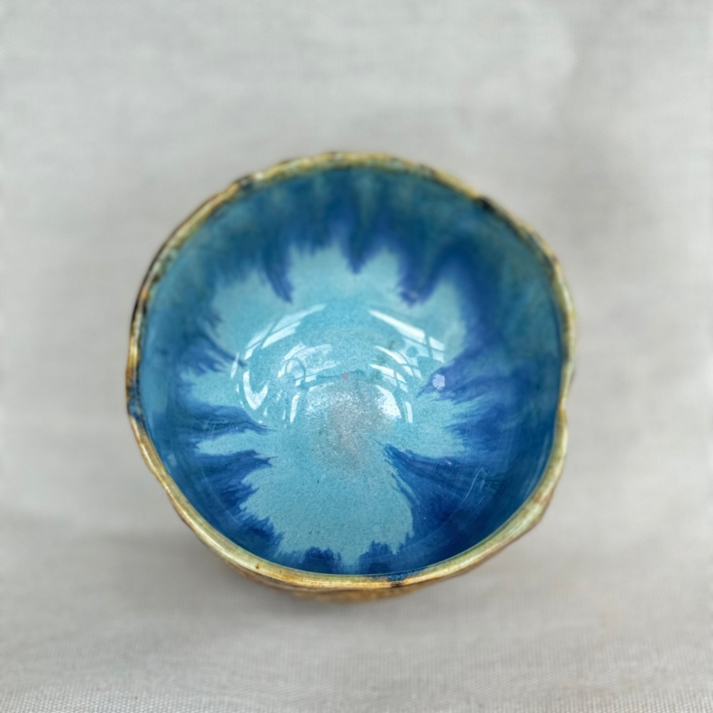 Small blue ceramic bowl on a light gray background