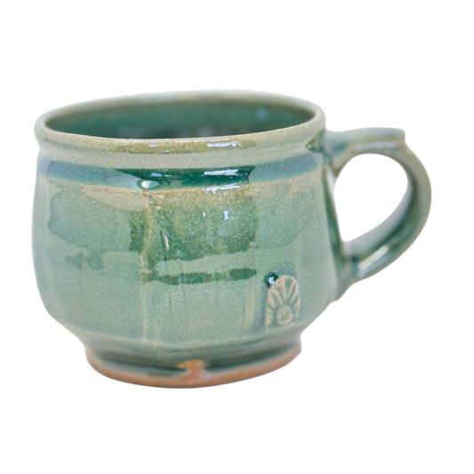 Green ceramic mug on a white background