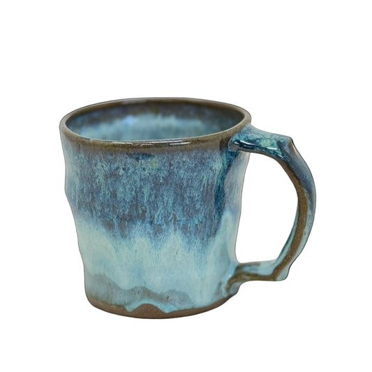 Blue ceramic mug with a handle on a white background