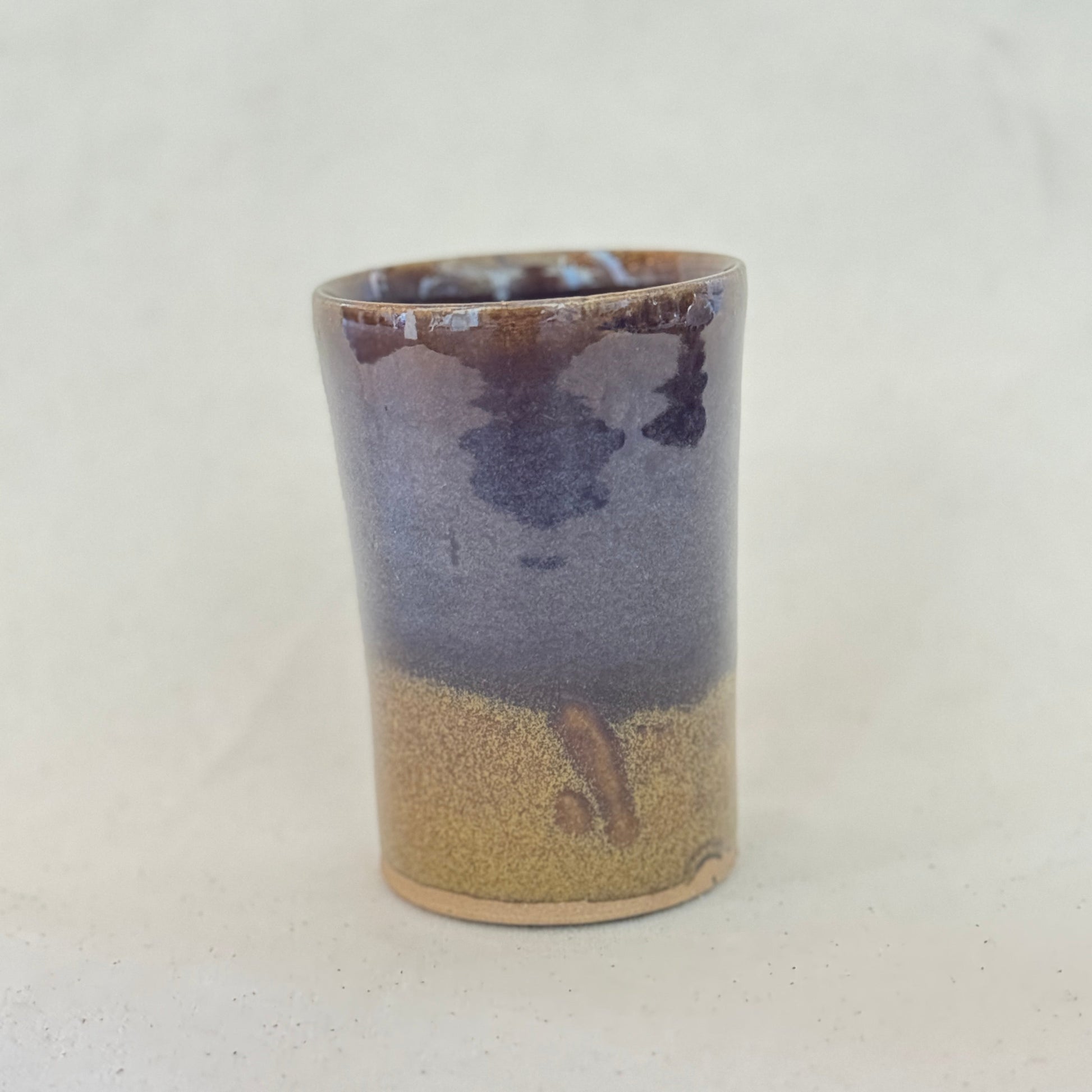 Ceramic cup with two-tone design on a white background