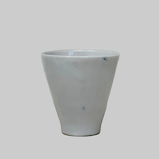 White tea cup on a light gray surface