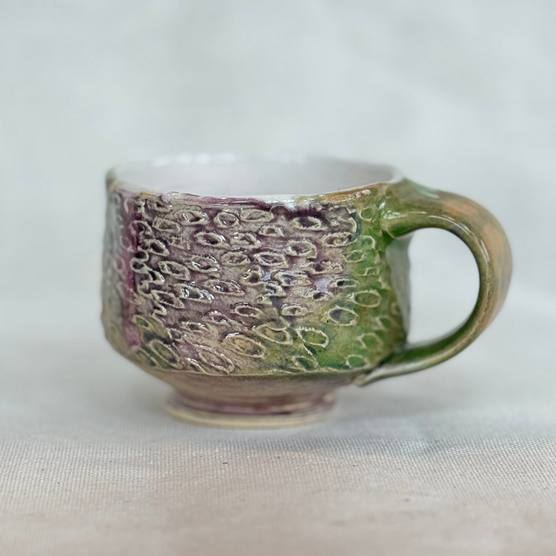 Ceramic mug with textured design on a white background