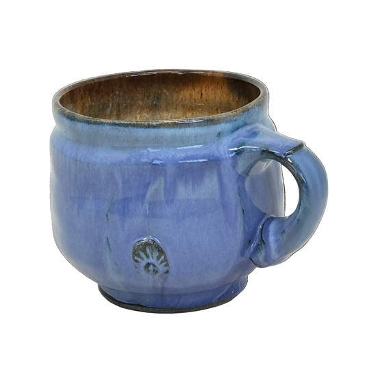 Blue ceramic mug with a handle on a white background