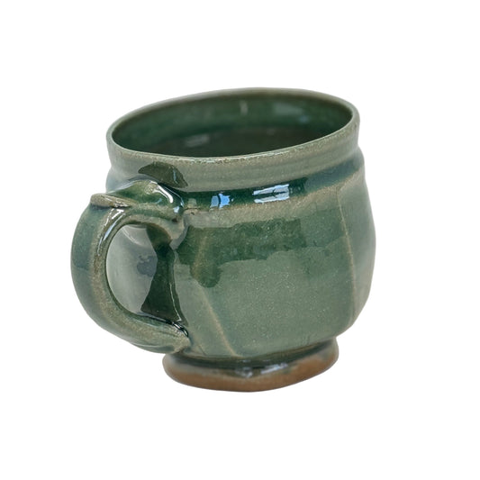 Green ceramic mug on a white background