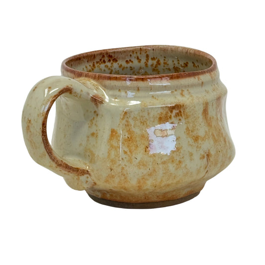 Ceramic mug with brown glaze on a white background