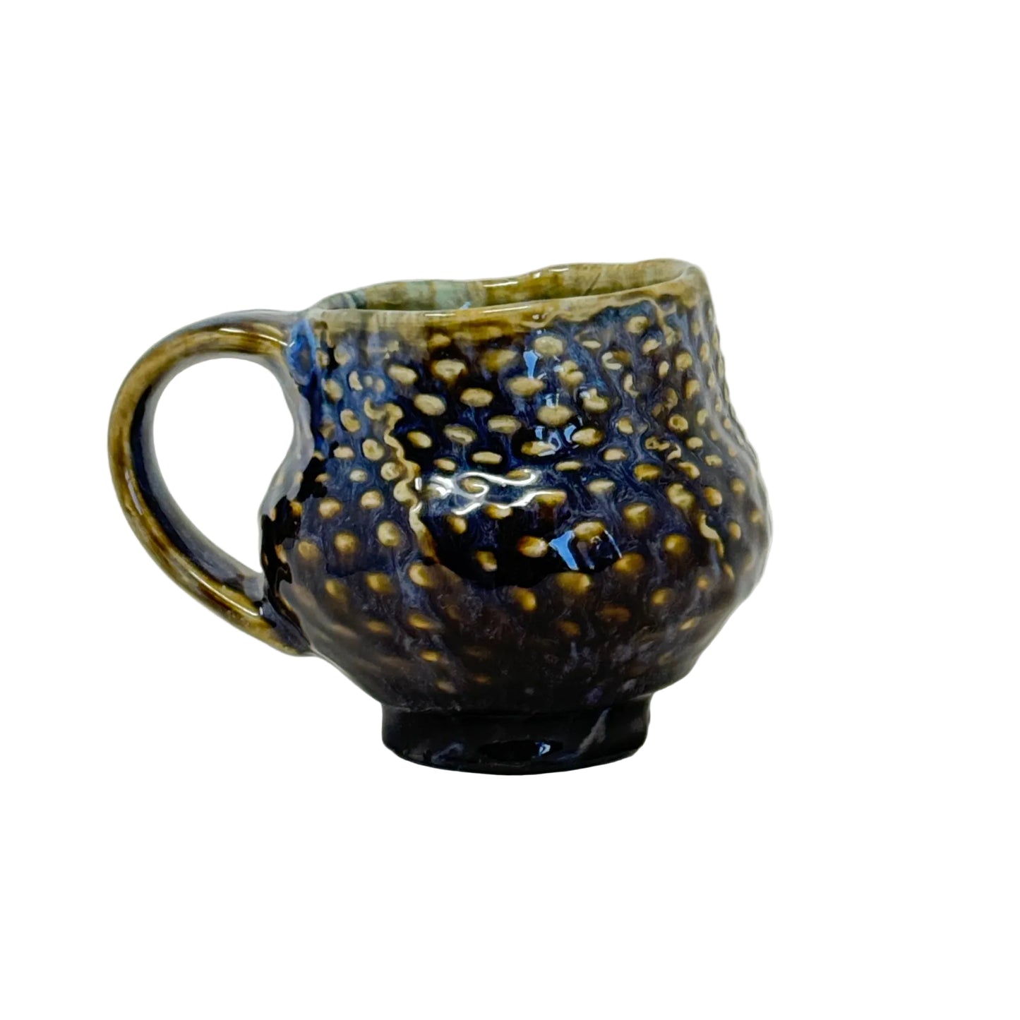 Ceramic mug with textured surface and handle on a white background