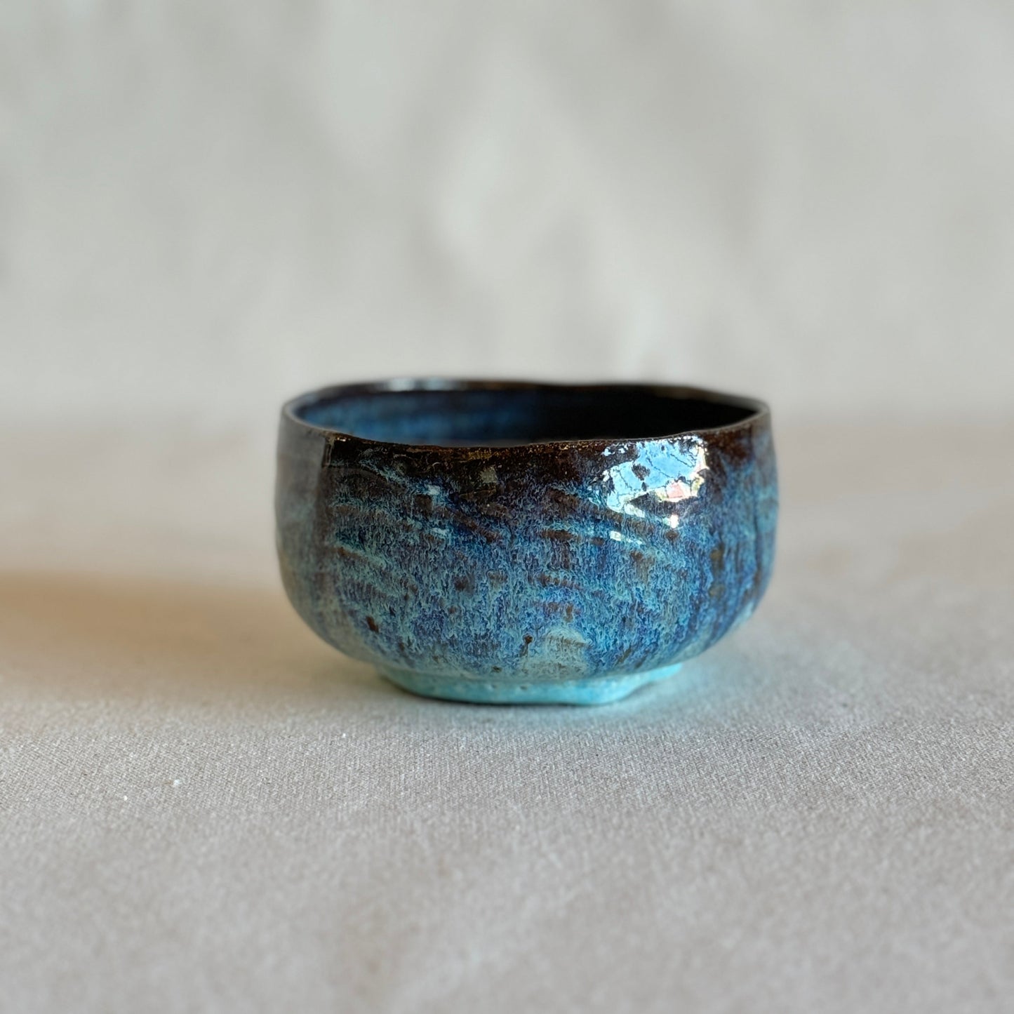 Blue ceramic bowl on a light gray background