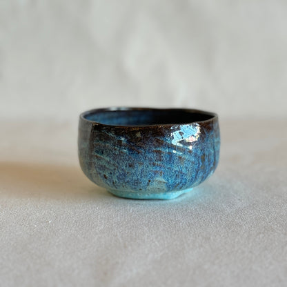 Blue ceramic bowl on a light gray background