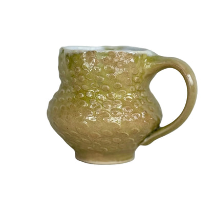 Green textured mug on a white background
