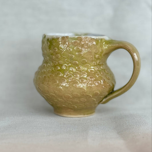 Green textured mug on a white background