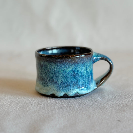 Blue ceramic mug on a light gray background