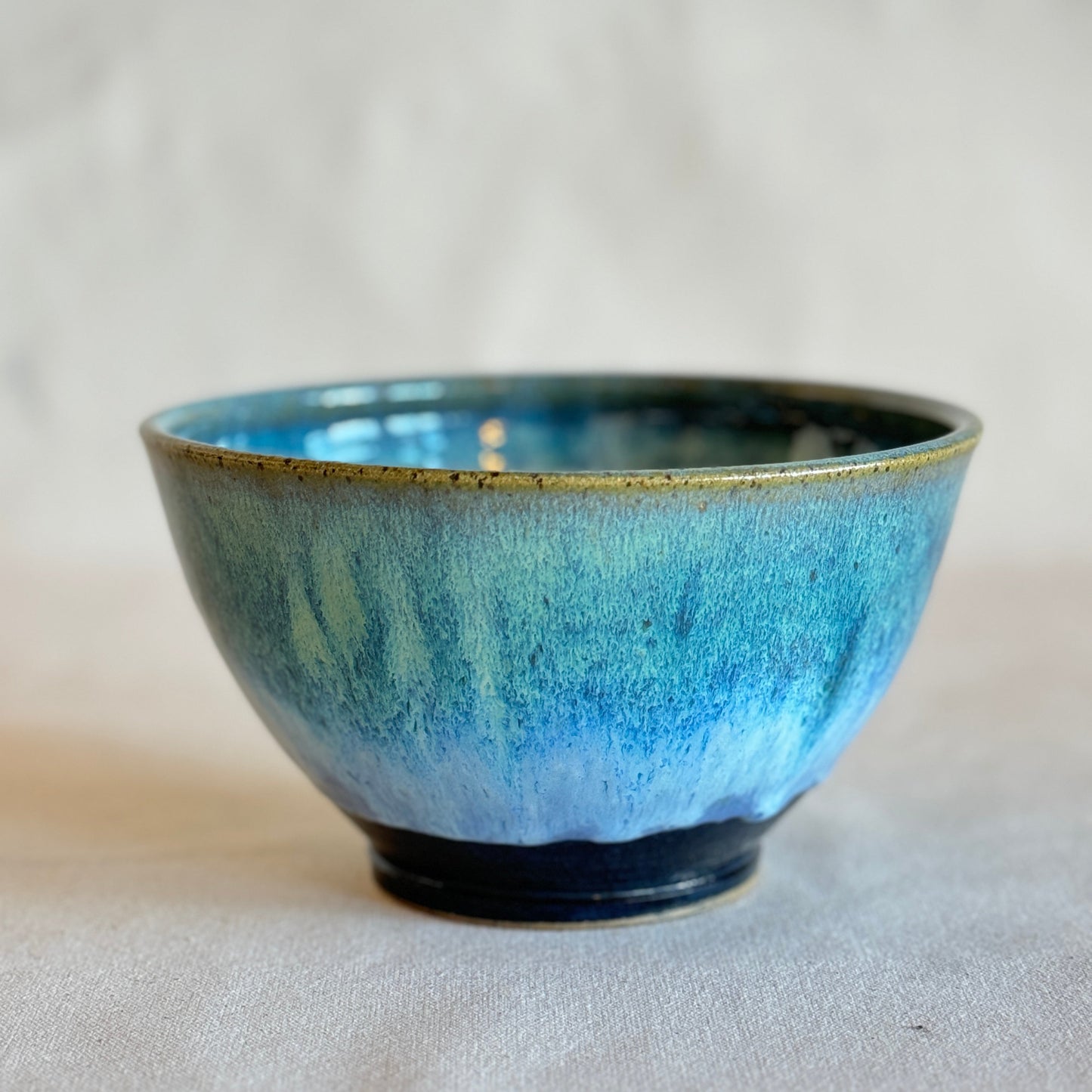 Blue ceramic bowl on a light gray background