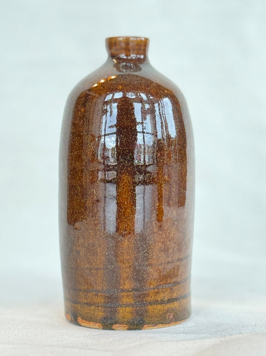 Brown ceramic bottle on a white background