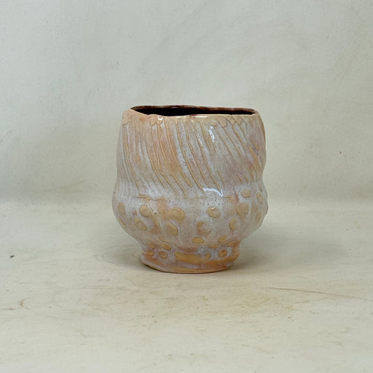 Ceramic cup with floral patterns on a white background