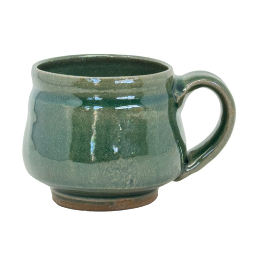 Green ceramic mug on a white background