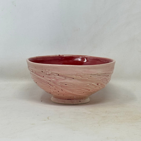Ceramic bowl with a textured surface on a white background