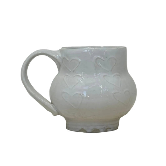 White ceramic mug with floral patterns on a light gray background