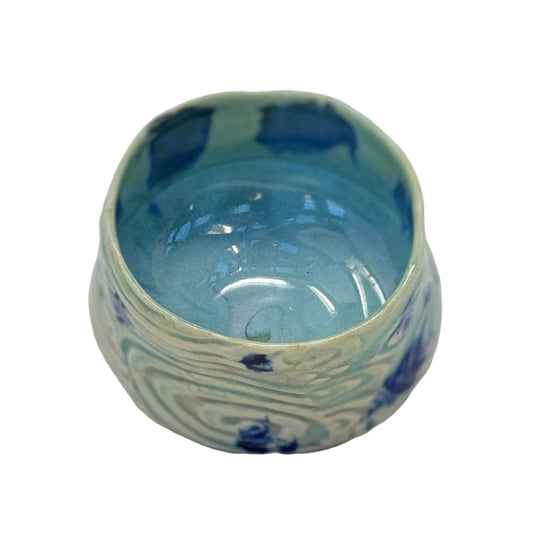 Ceramic bowl with blue and white patterns on a white background