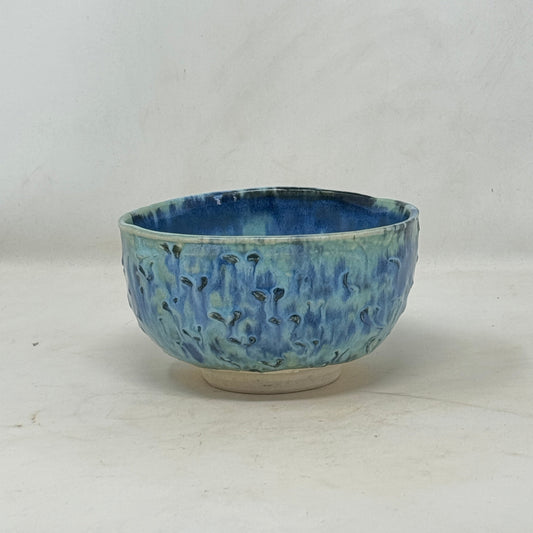 Blue ceramic bowl on a white background
