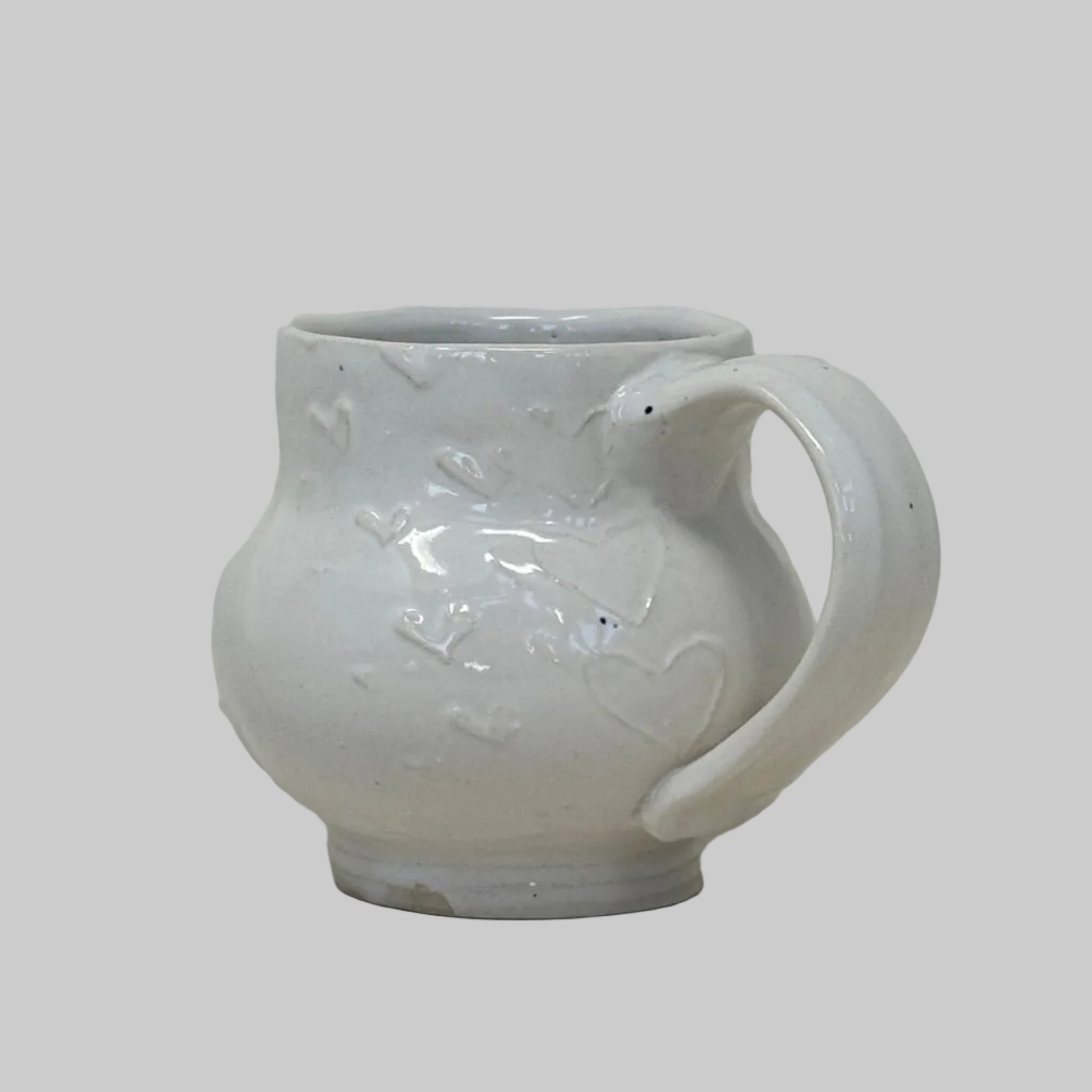 White ceramic mug with floral design on a white background