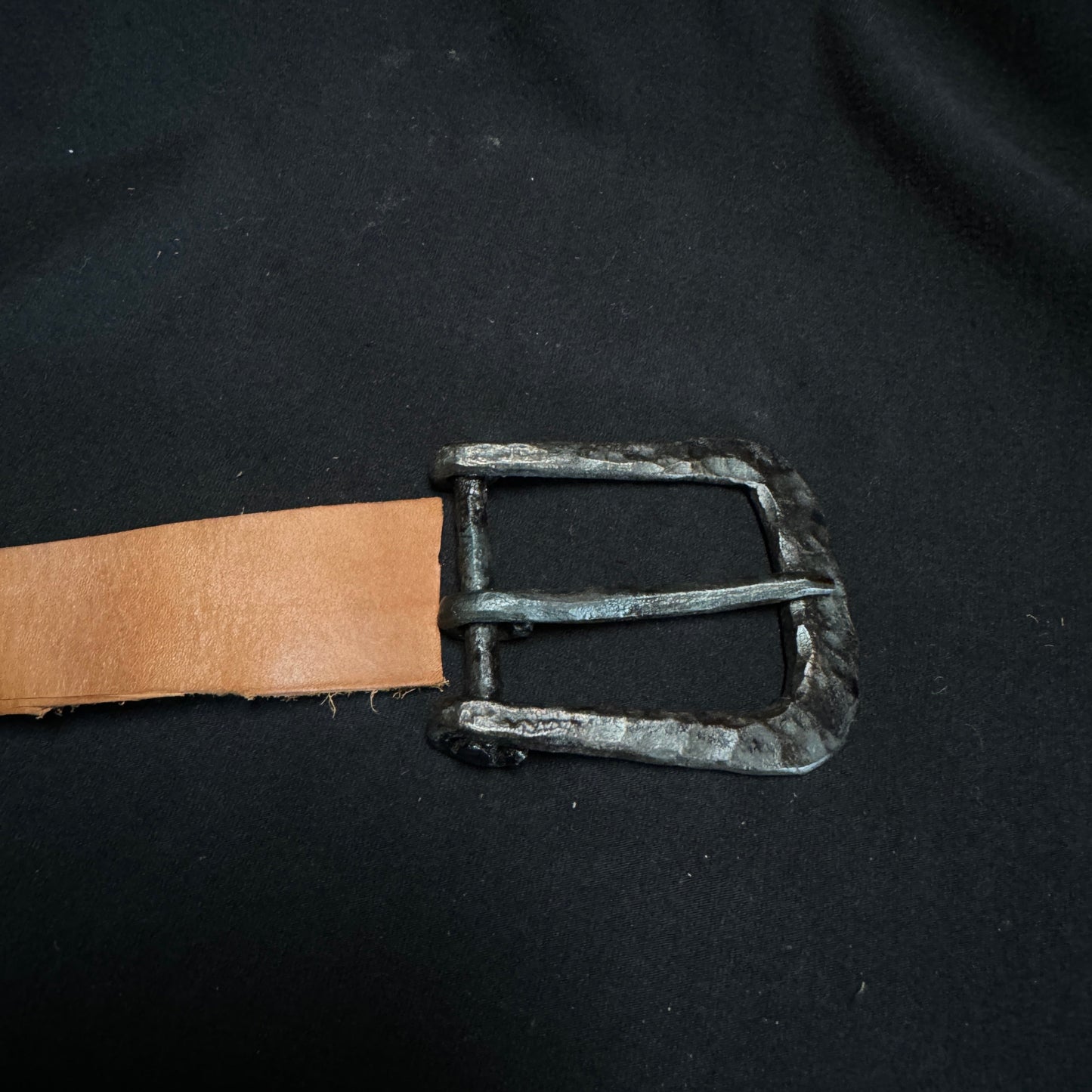 Belt with a metal buckle on a black background