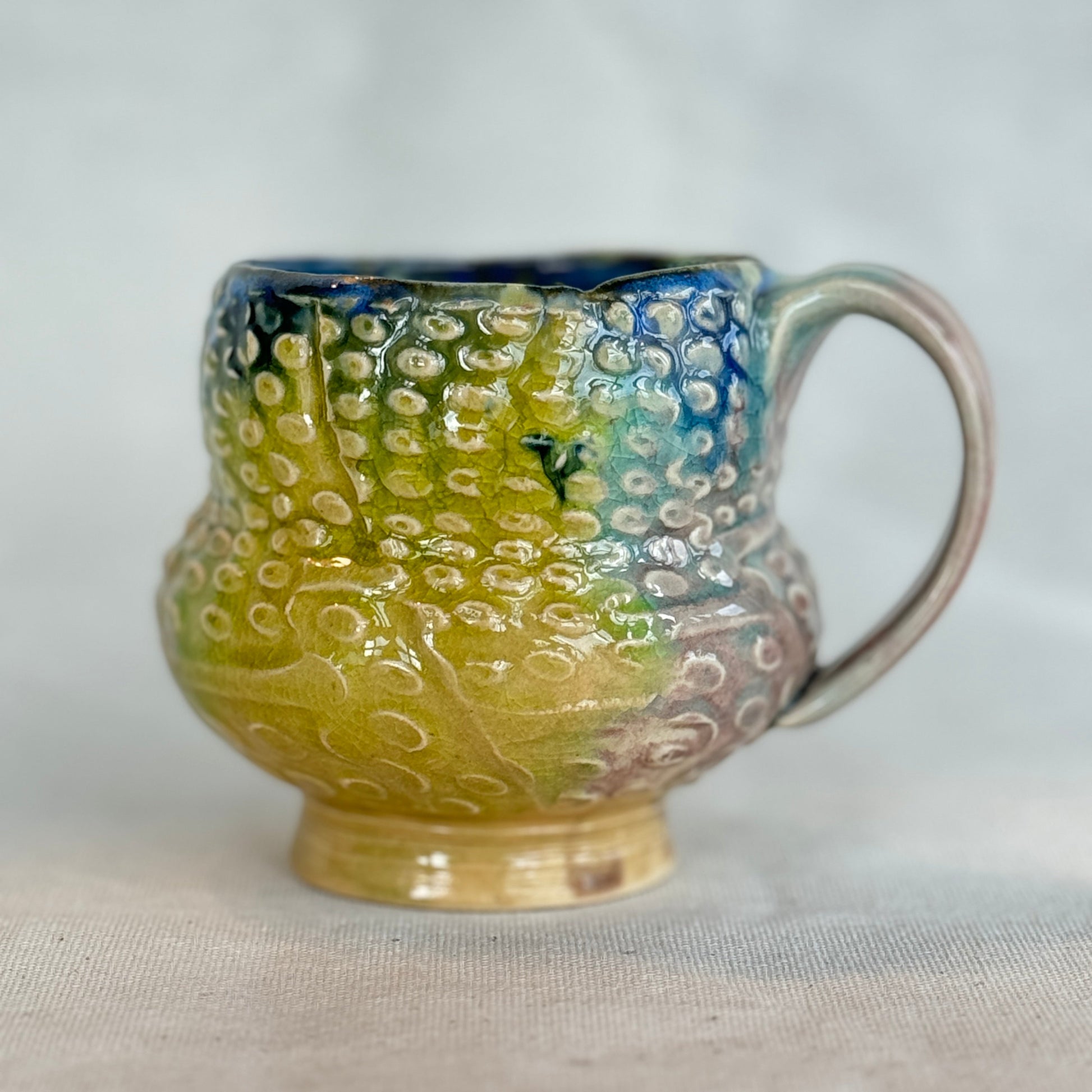 Ceramic mug with textured design on a white background