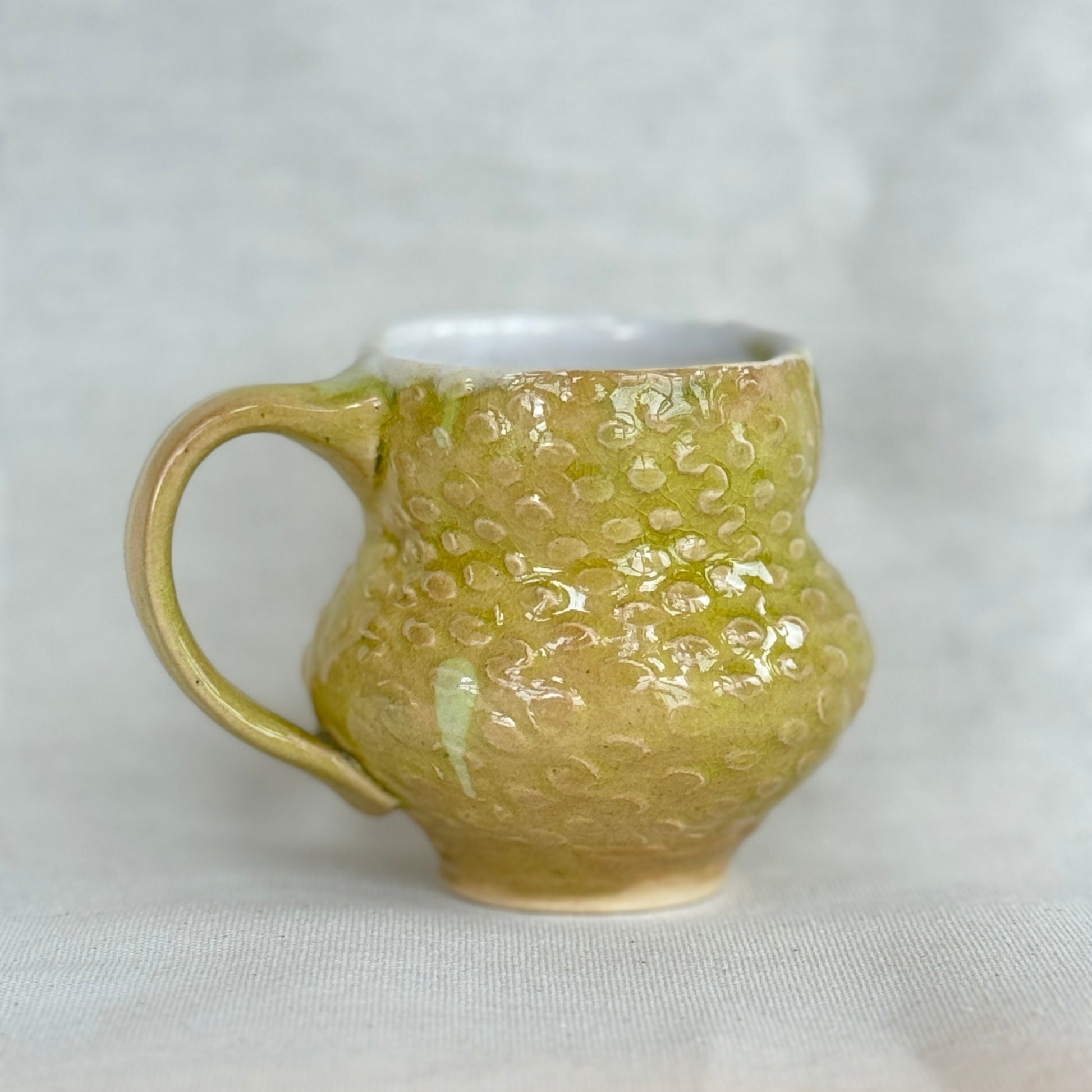 Green textured mug on a light gray background