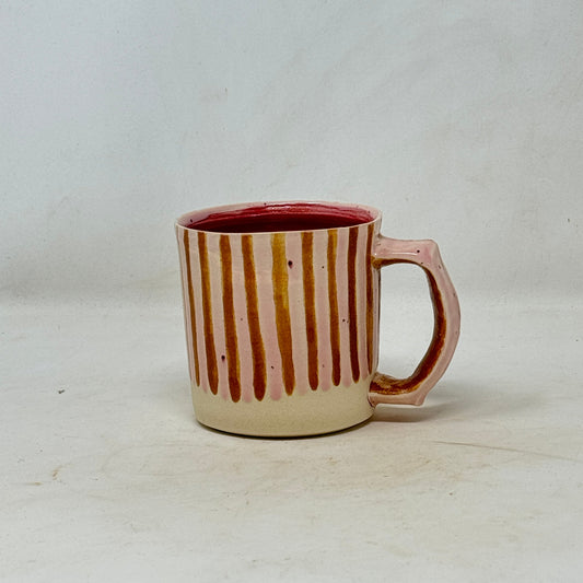 Ceramic mug with striped design on a white background