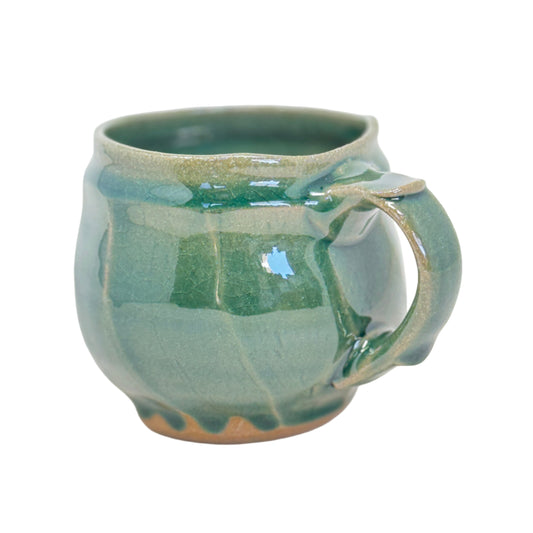 Green ceramic mug on a white background