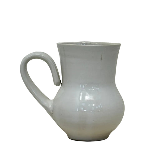White ceramic mug on a light gray surface