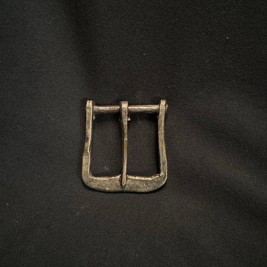 Bronze belt buckle on a black background