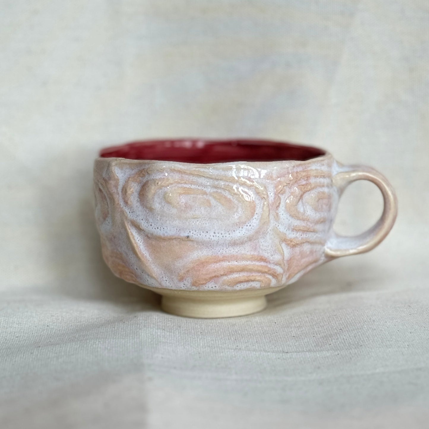 Ceramic mug with marbled design on a white background