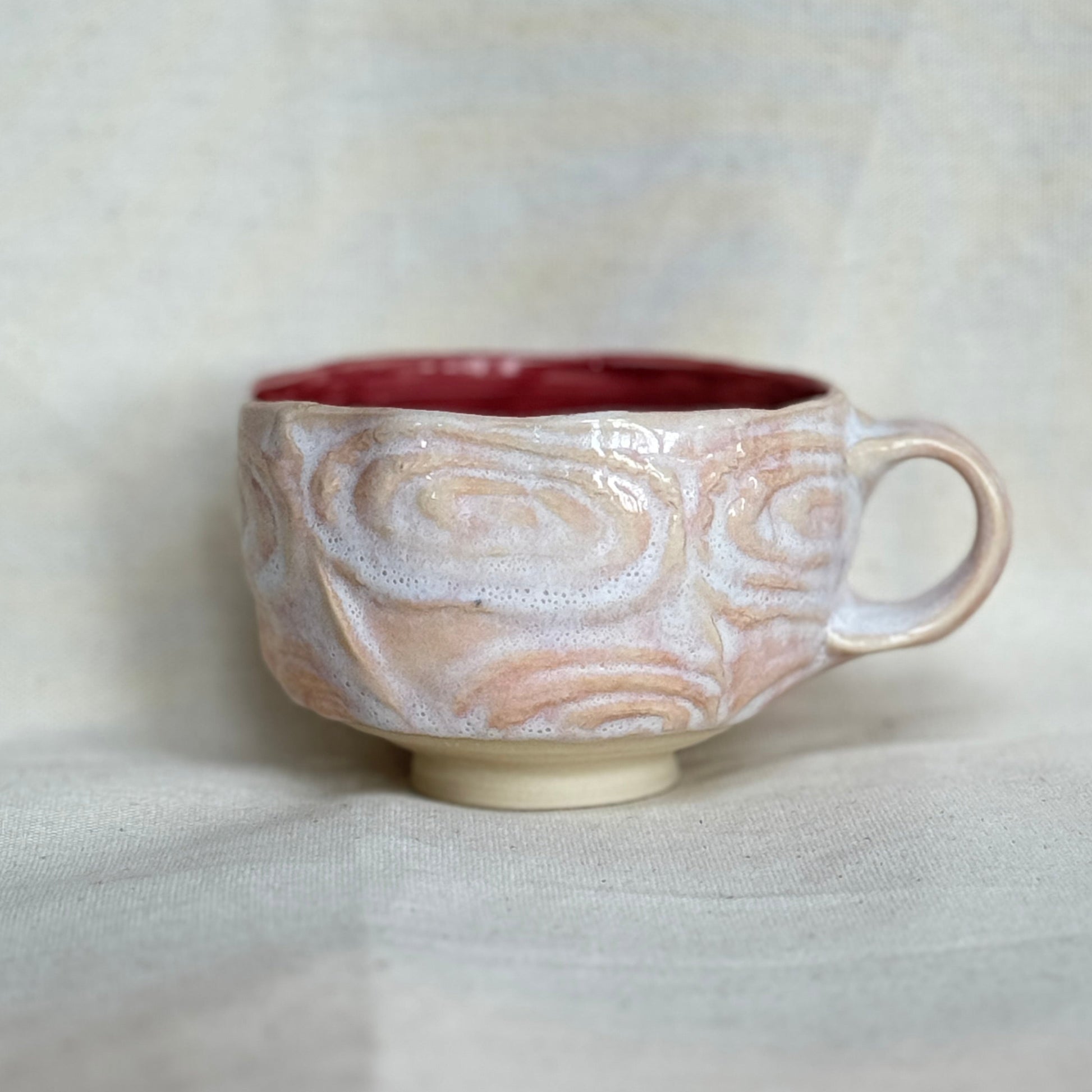 Ceramic mug with marbled design on a white background