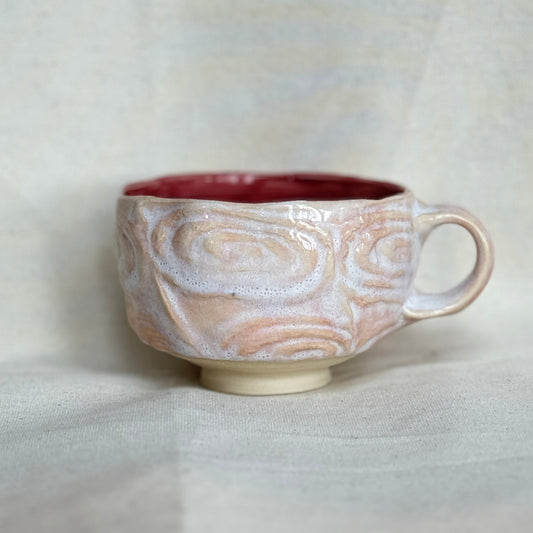 Ceramic mug with marbled design on a white background
