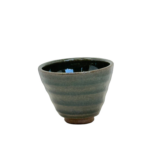 Ceramic cup with ribbed texture on a white background
