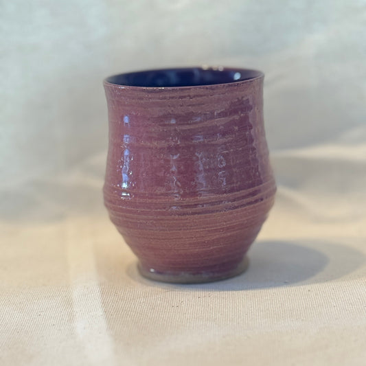 Purple ceramic cup on a white background