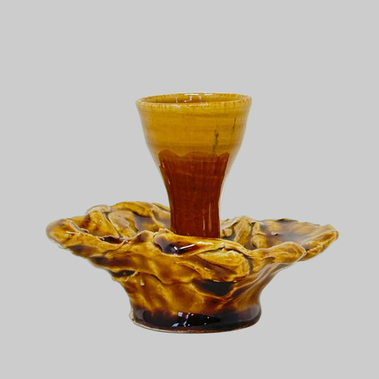 Decorative candle holder with a textured surface on a white background