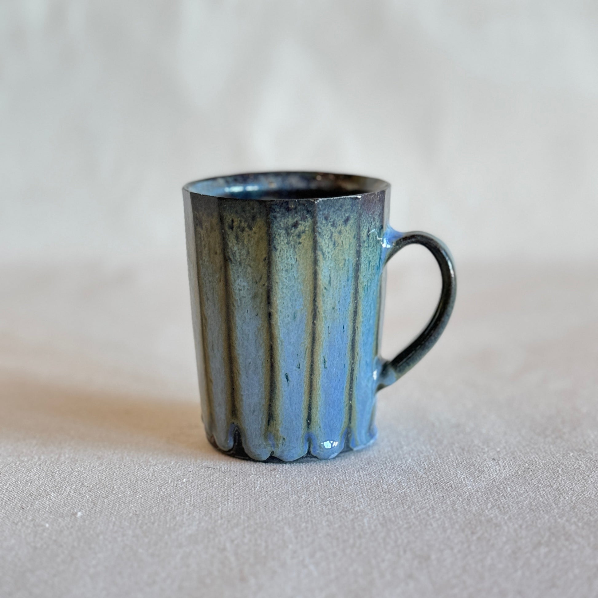 Blue ceramic mug on a light gray background